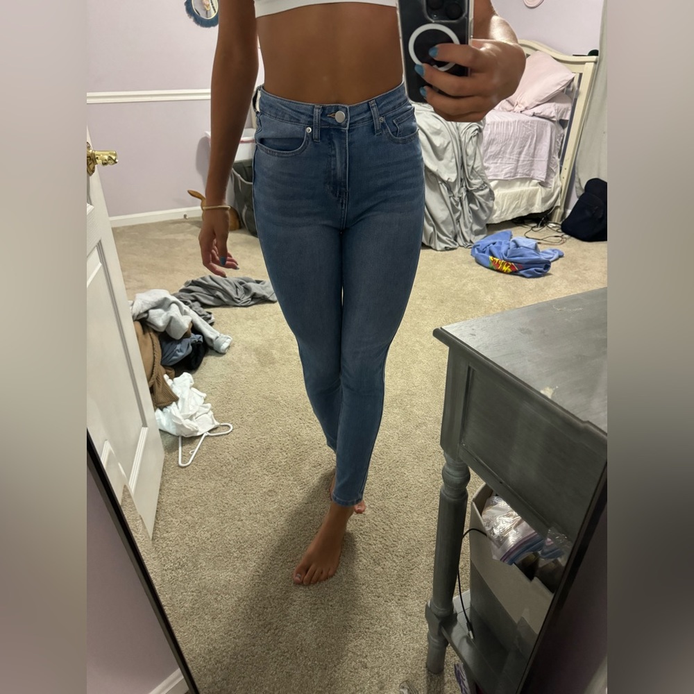 Skinny dark blue jeans with no rips.